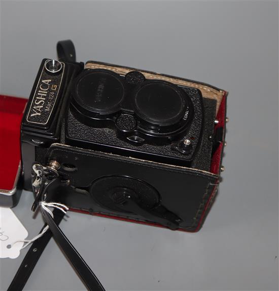 A Yashica Mat-124G TLR camera, serial no. 9080895 with Yashinon f/2.8 80mm and f/3.5 80mm lenses, cased.